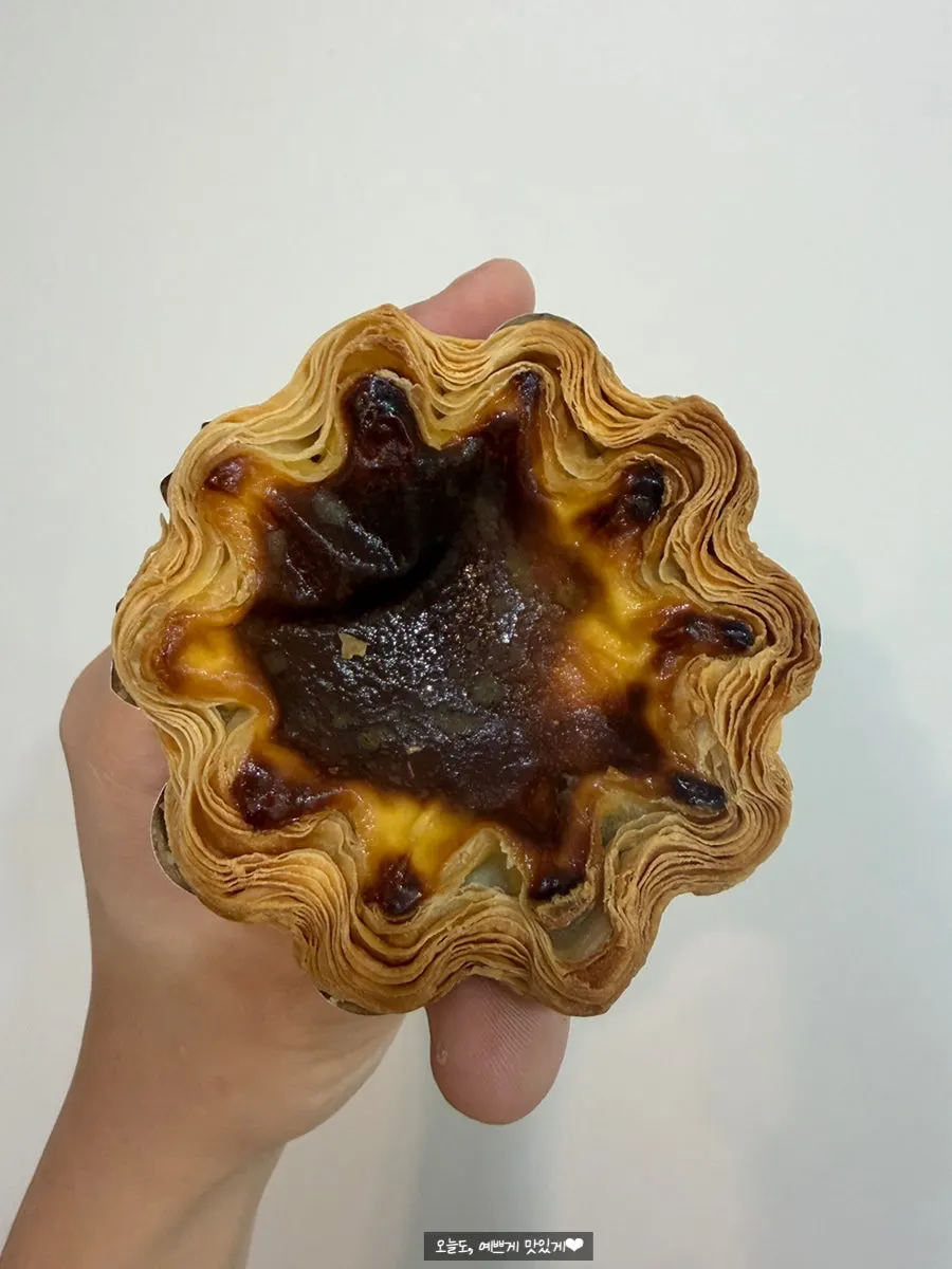 An egg tart with visible pie layers