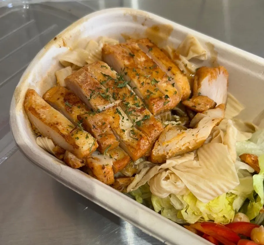 Tofu noodle protein box mixed with sauce and chickpeas
