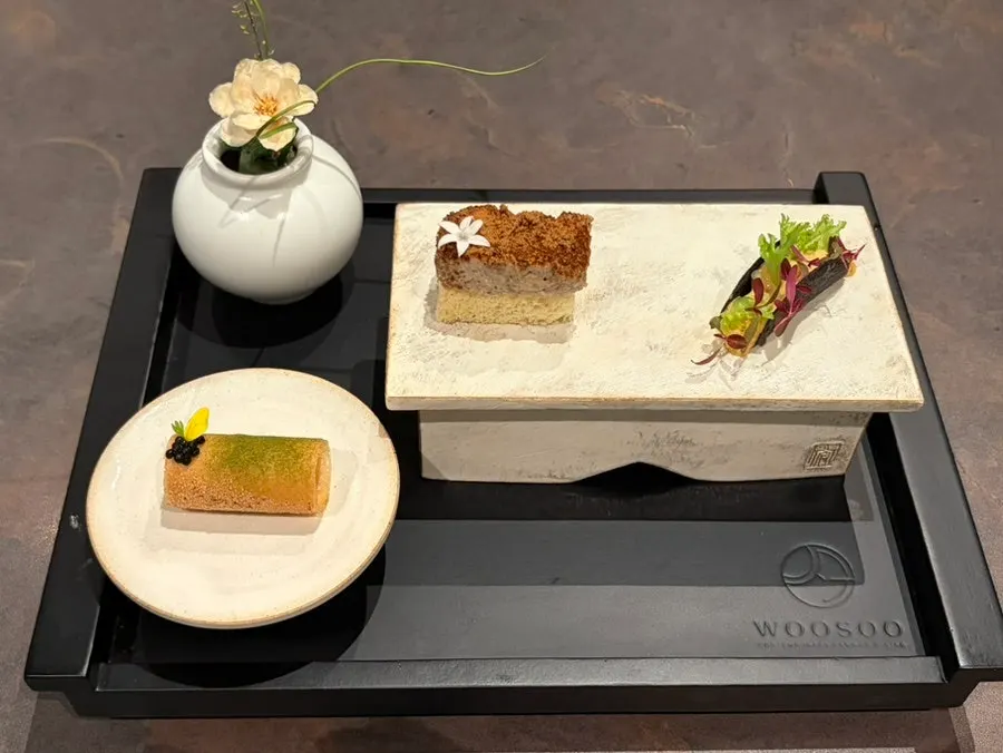 Three bite-sized dishes: hanwoo bulgogi, scallop with clam, and lobster