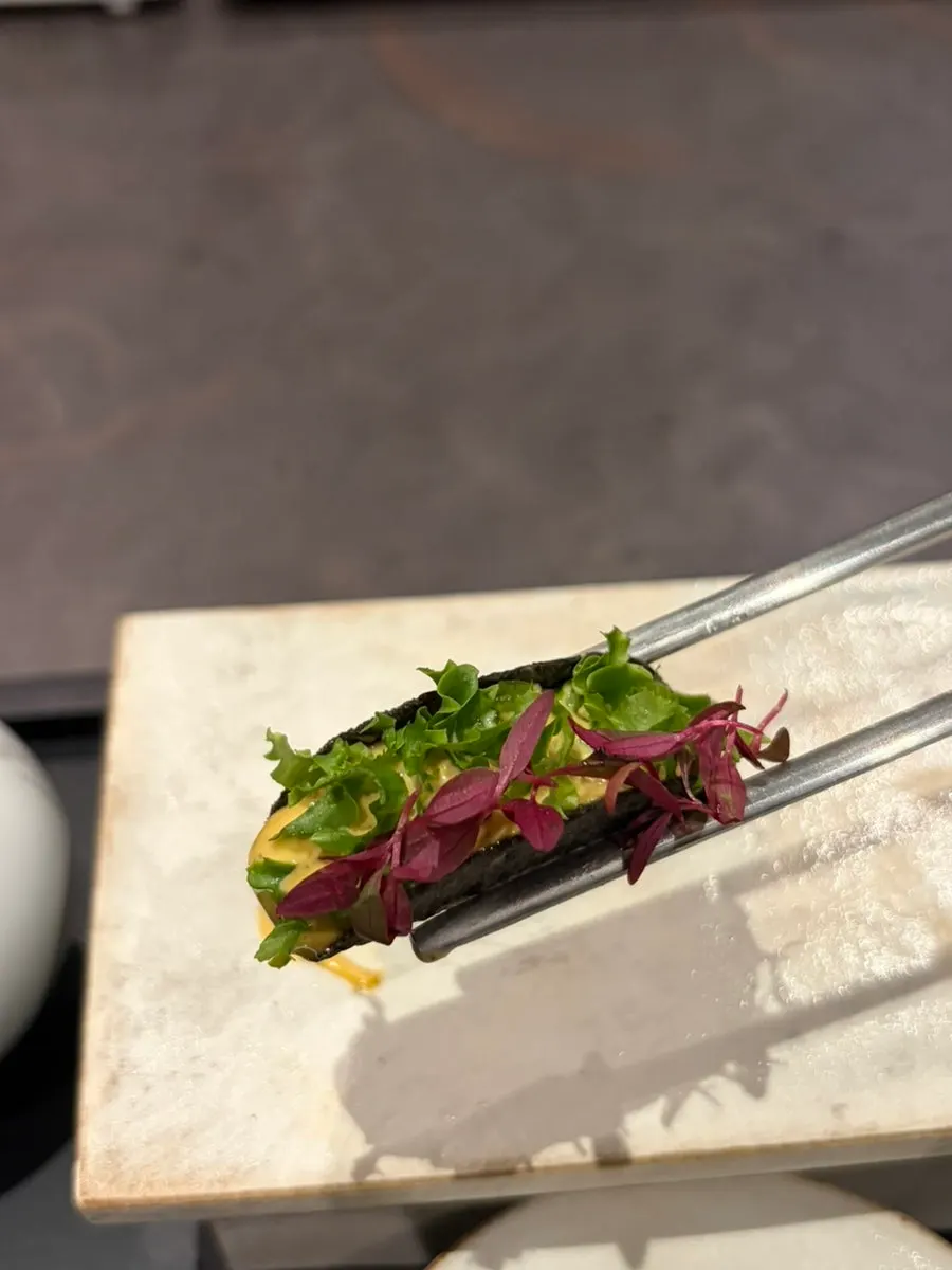 A bite-sized dish made with pollock roe gim, abalone-innard rice, and sweet shrimp