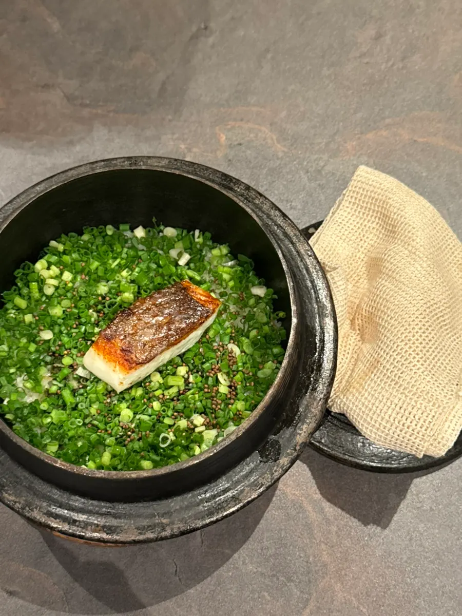 Seasonal fish hot-pot rice, portioned out by staff