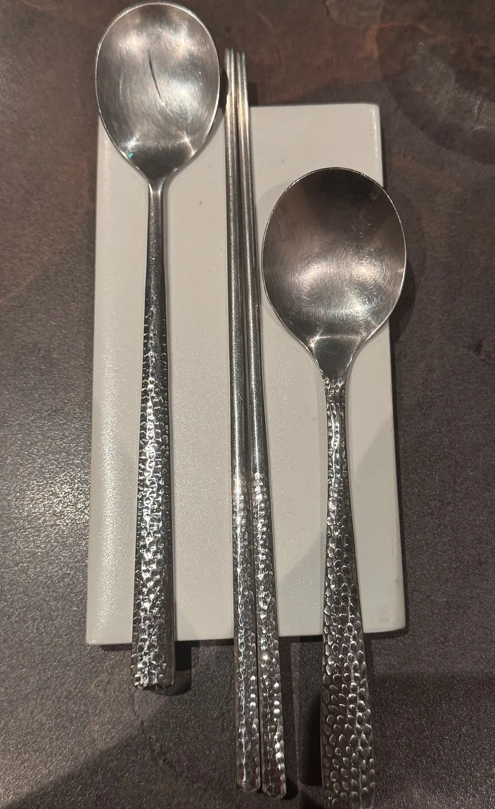 Table setting with barley tea, napkins, and silver utensils