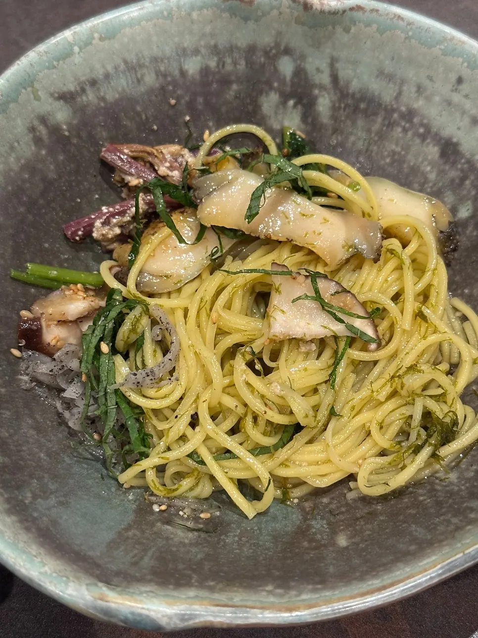 Chopsticks lifting a portion of the abalone five-color gardenia noodles