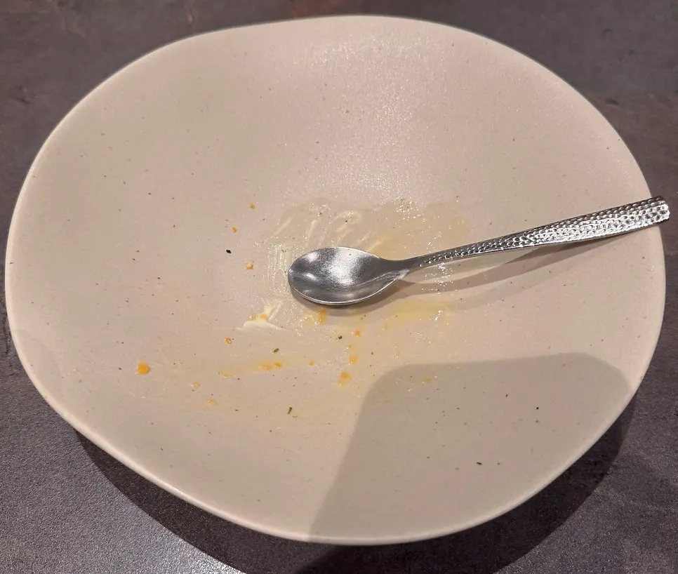 Corn ice cream dessert drizzled with green tangerine cream sauce