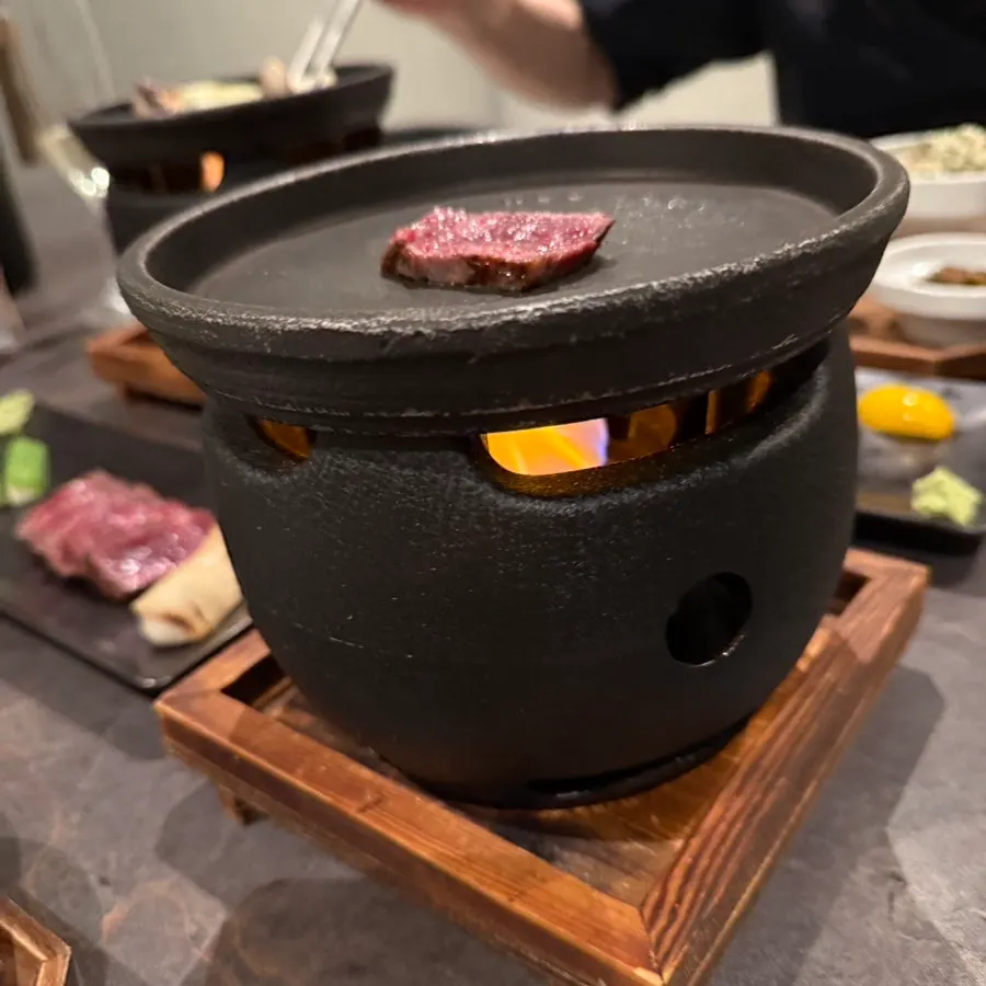 Hanwoo sirloin cooking on the charcoal grill