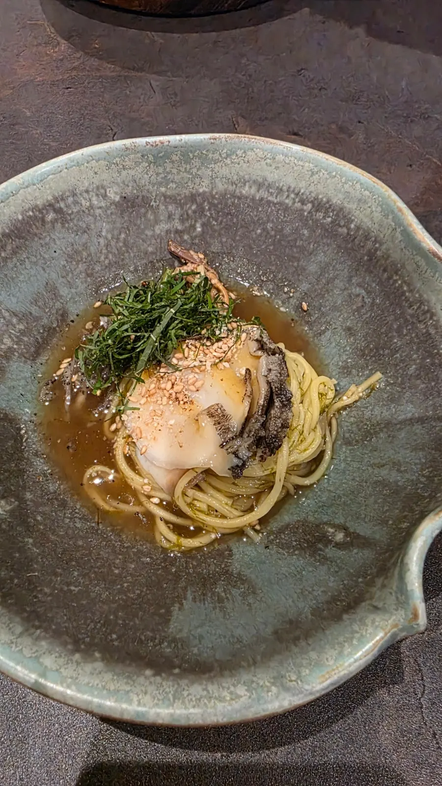 Abalone gardenia noodles topped with abalone and herbs