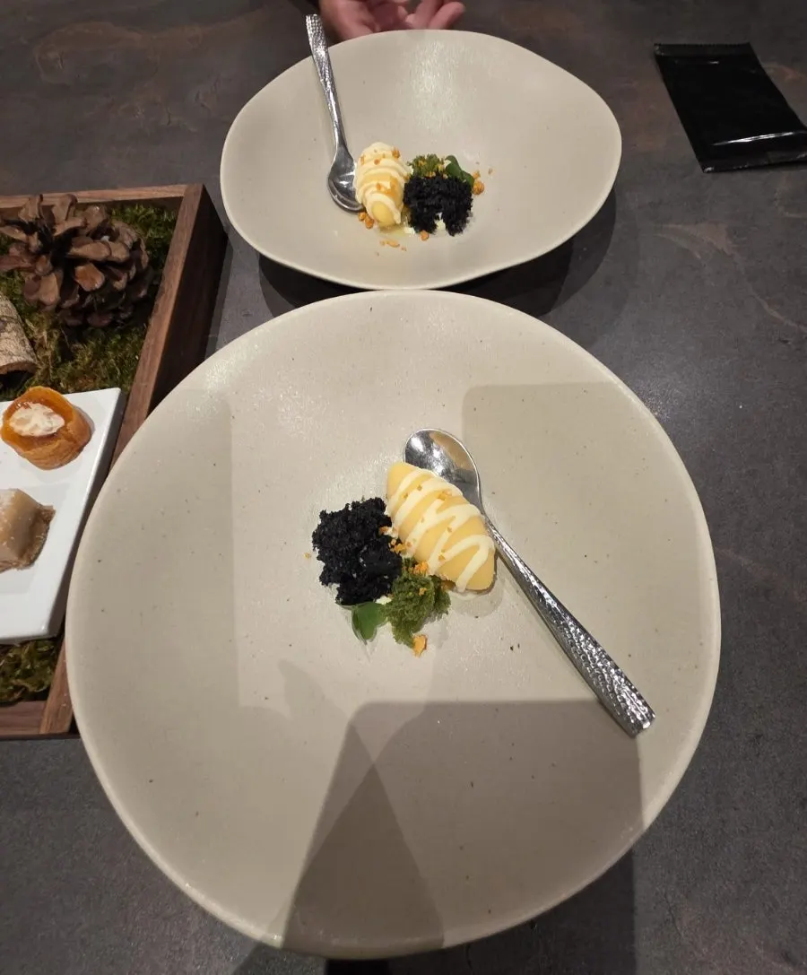 Corn ice cream topped with corn crumble and green tangerine cream sauce