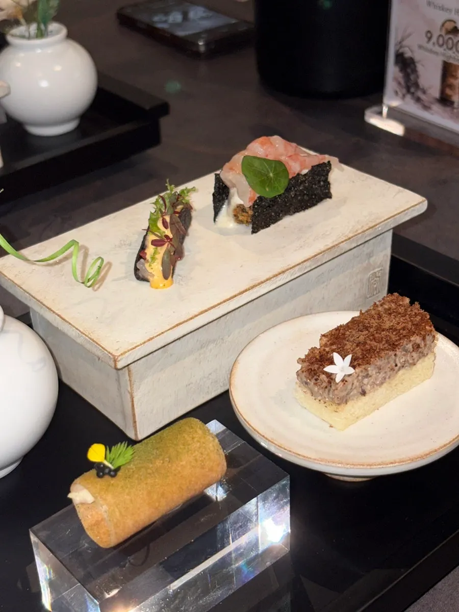 Close-up of bulgogi sandwich, lobster taco and other bite-sized dishes