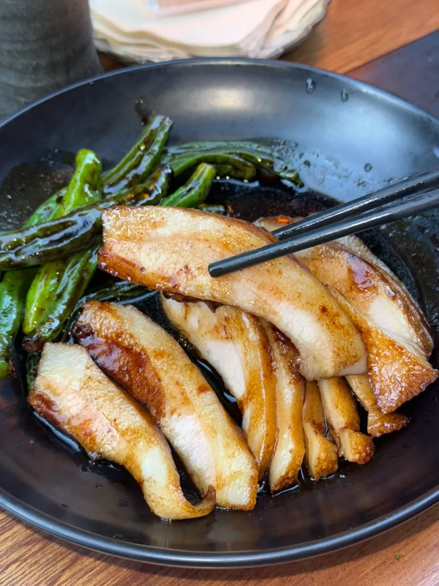 Close-up of pork jowl coated in braising sauce