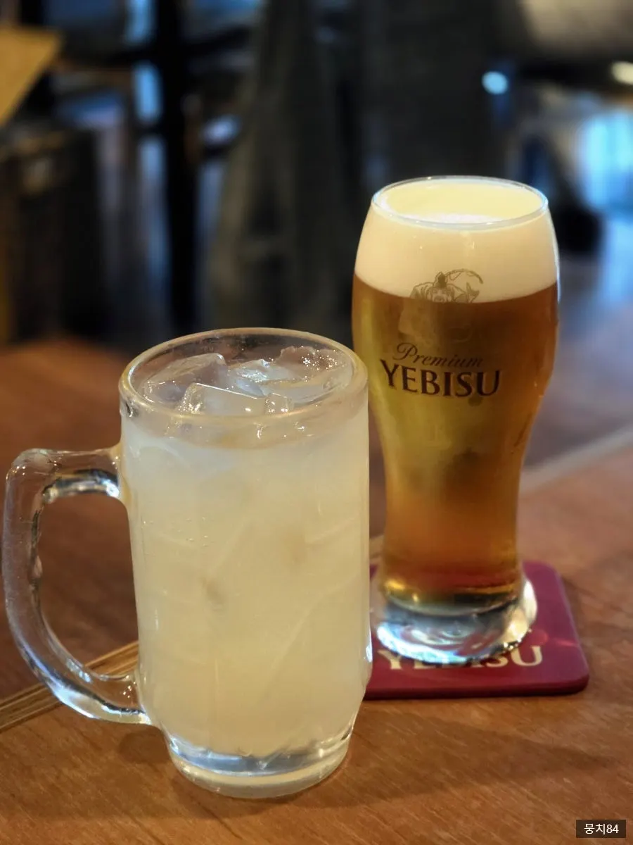 A glass of Ebisu draft beer and a yuzu highball