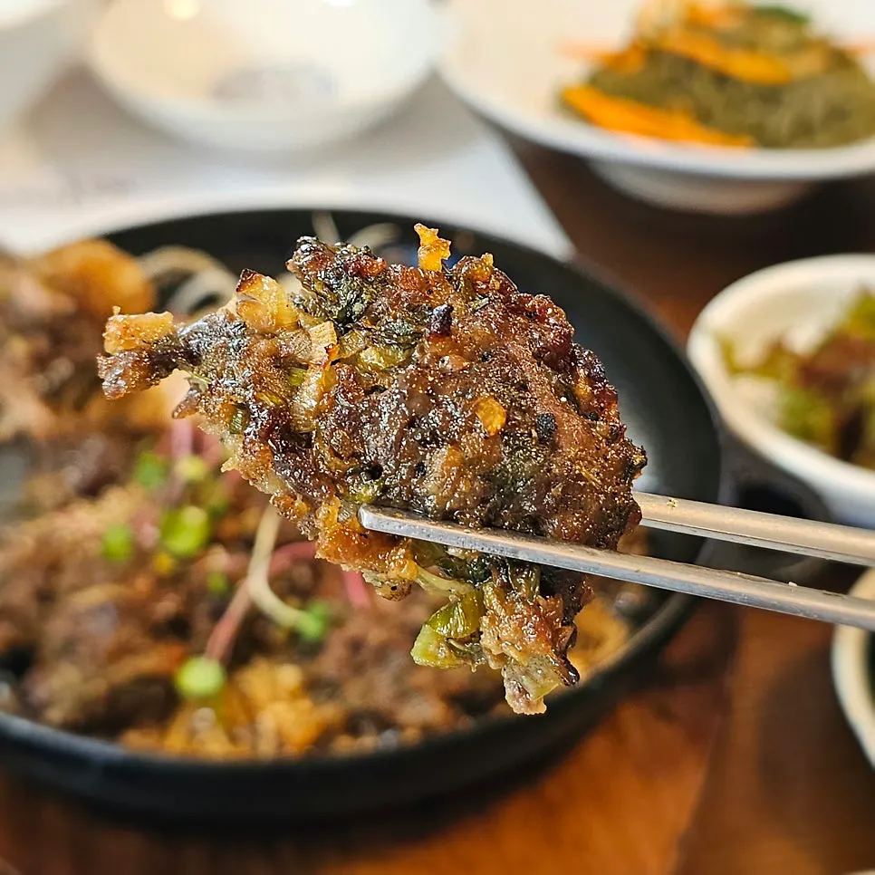 Close-up of tteokgalbi with onion and enoki mushroom