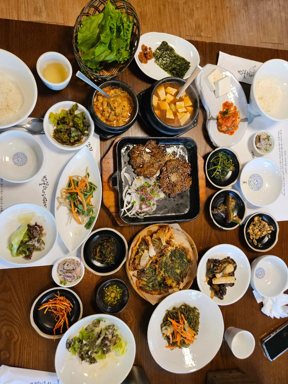 Full table spread of the minari tteokgalbi set at Bapkkot Hana Pieotne