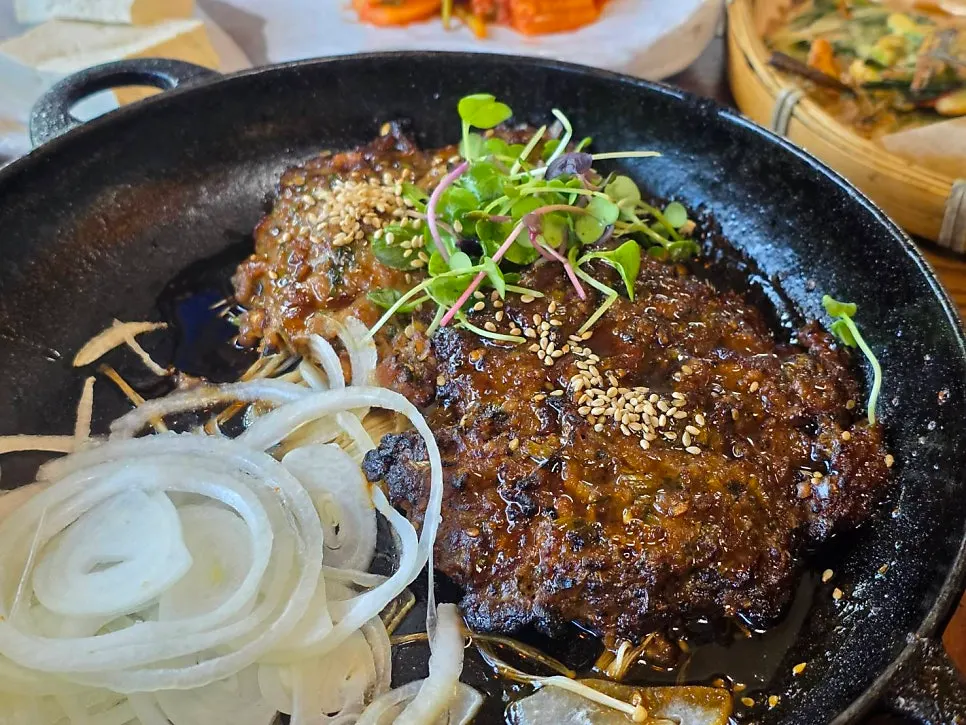 Table with minari tteokgalbi and charcoal-grilled pork