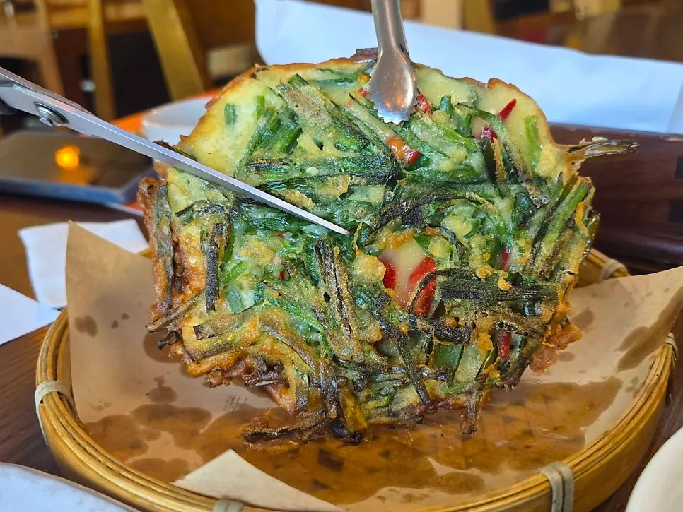 Picking up a piece of tteokgalbi with chopsticks