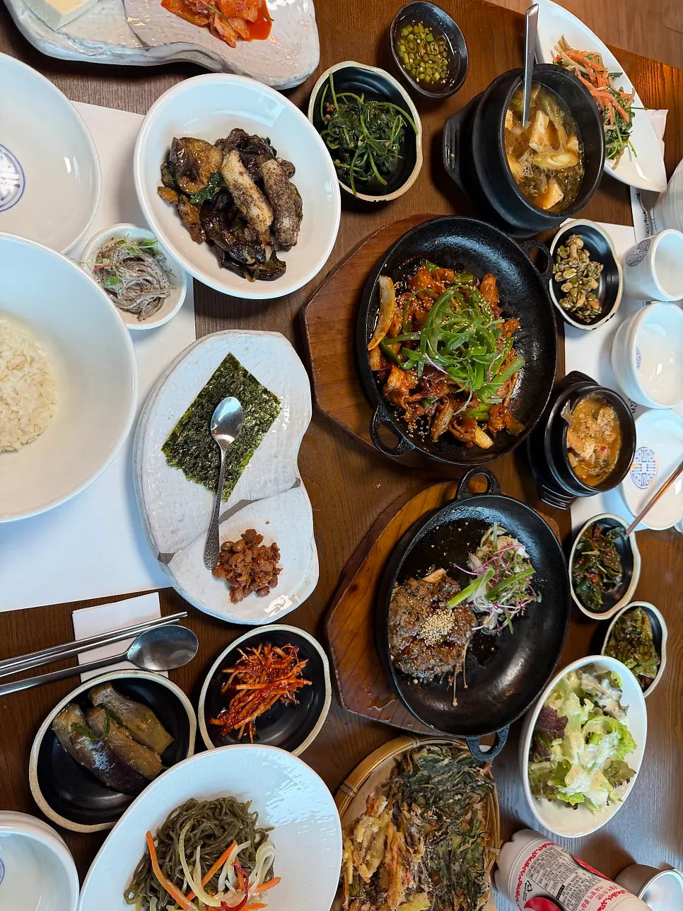 Hanjeongsik side dishes being set out on the table