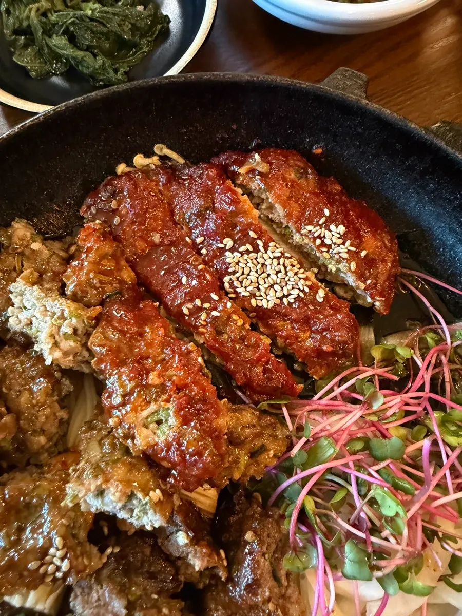 A piece of soy-sauce tteokgalbi with a charred aroma
