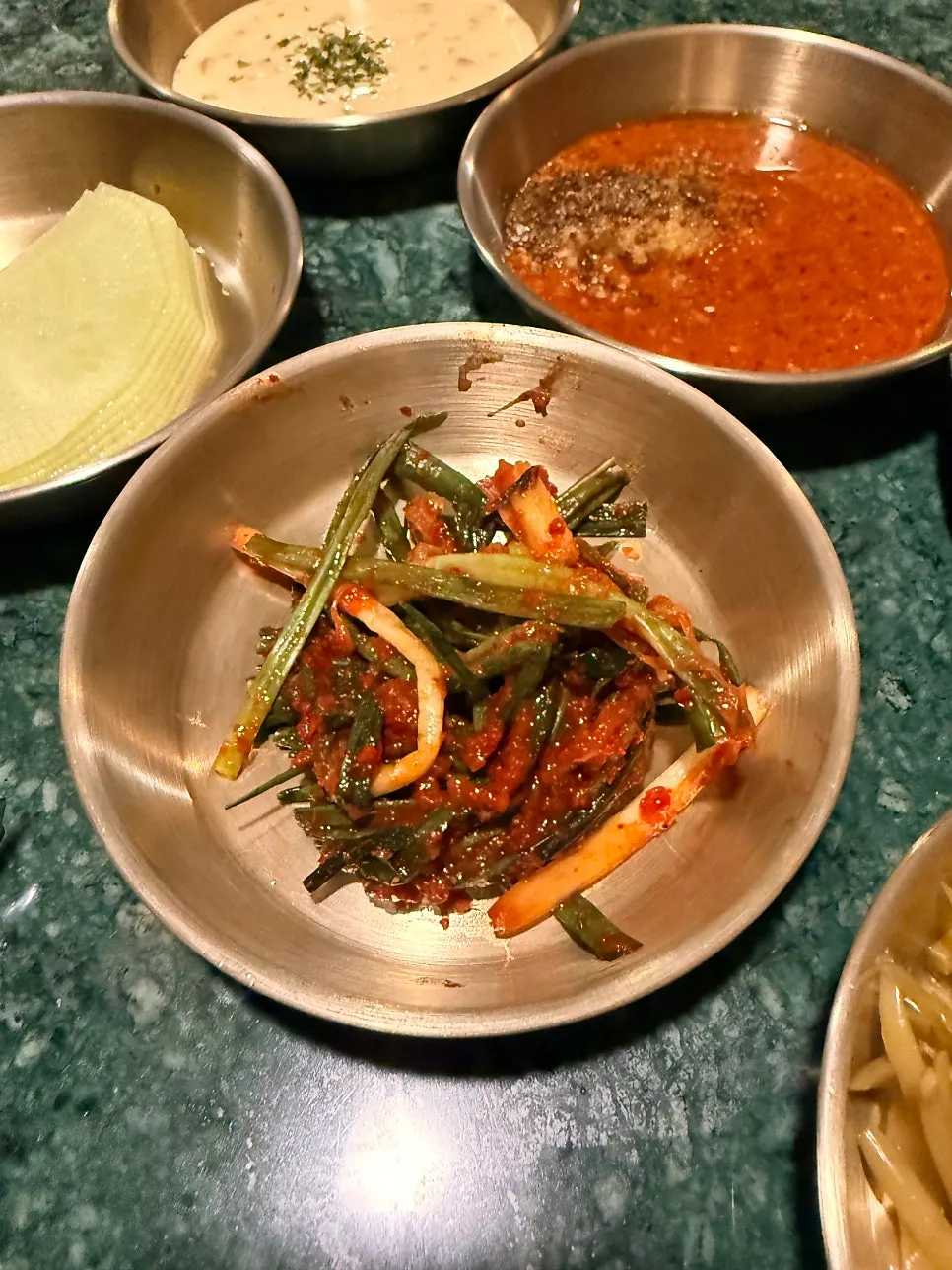 Full spread of leafy wraps and side dishes at Gongjung Dodeok