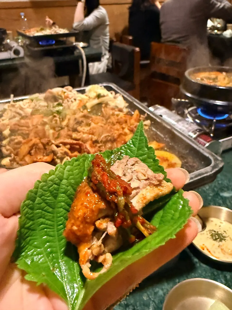 Duck bulgogi and rice cakes cooking on the grill