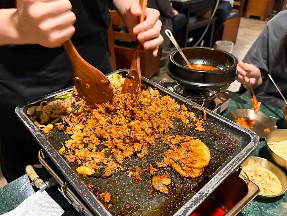 Staff member frying the self-fried rice