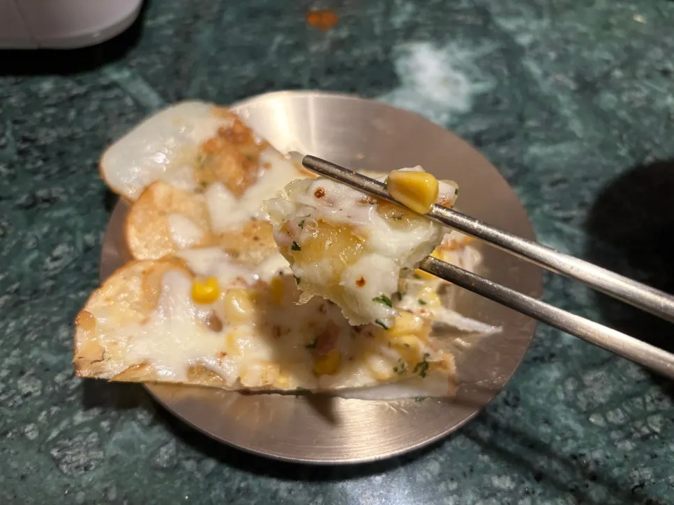 Cheese potato pancake topped with cheese and corn kernels