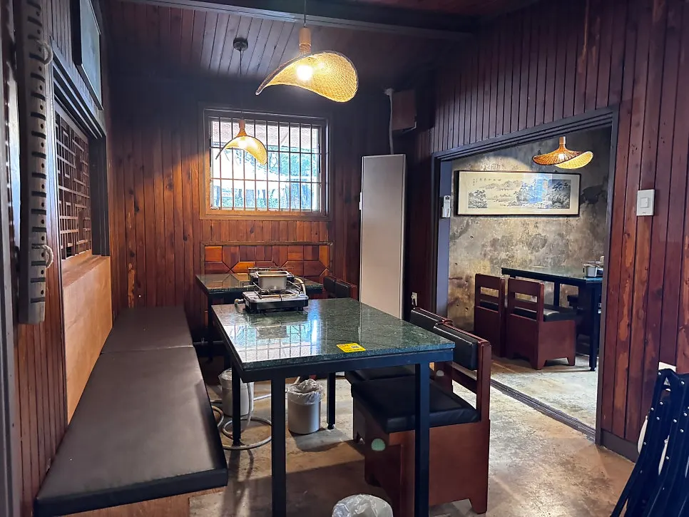 Seating area inside Gongjung Dodeok with soft lighting
