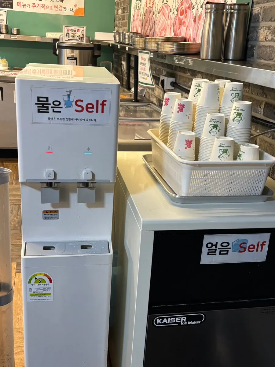 Sign at the self-serve corner asking guests to request refills