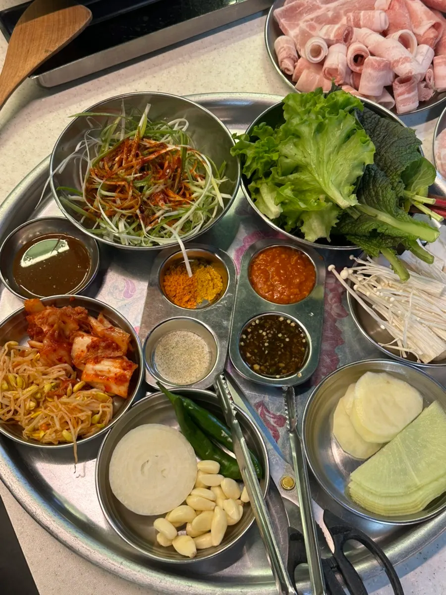 Side dish corner with bean sprouts, kimchi, and pickled radish
