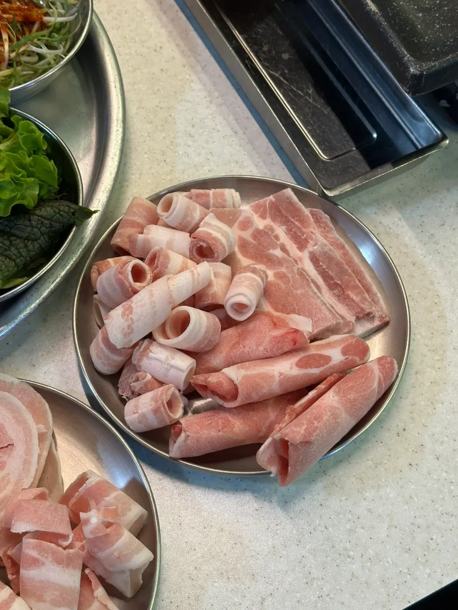 A plate loaded with several kinds of pork cuts