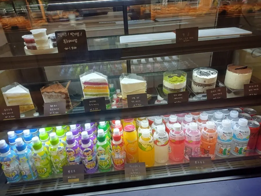 Refrigerated display case with cakes and kids' drinks