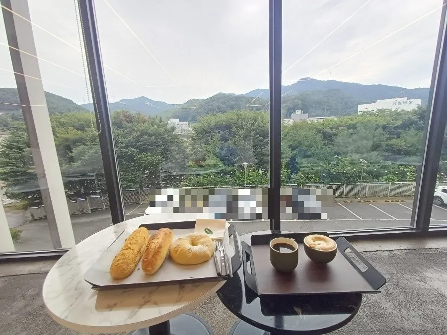 Enjoying coffee and bread at a window seat