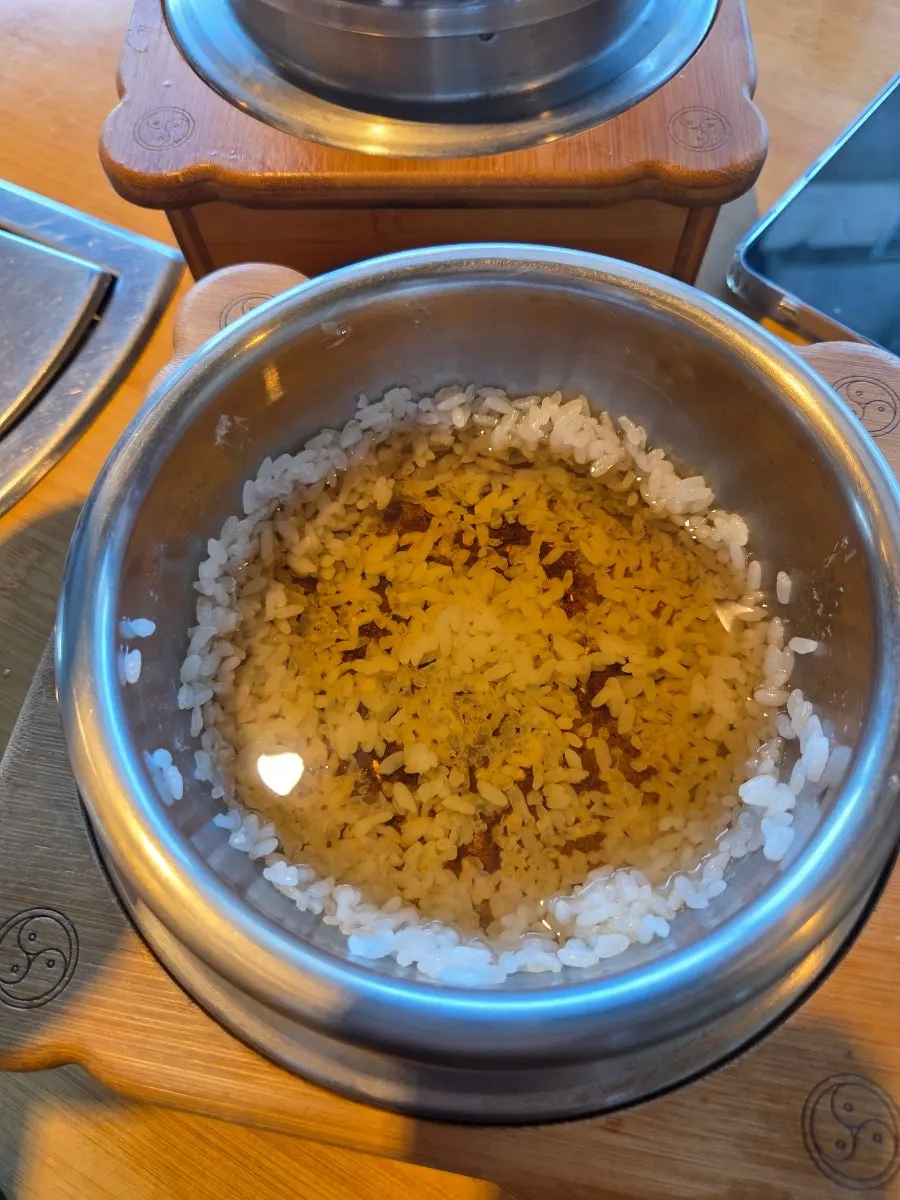 Water poured into the emptied pot to make nurungji