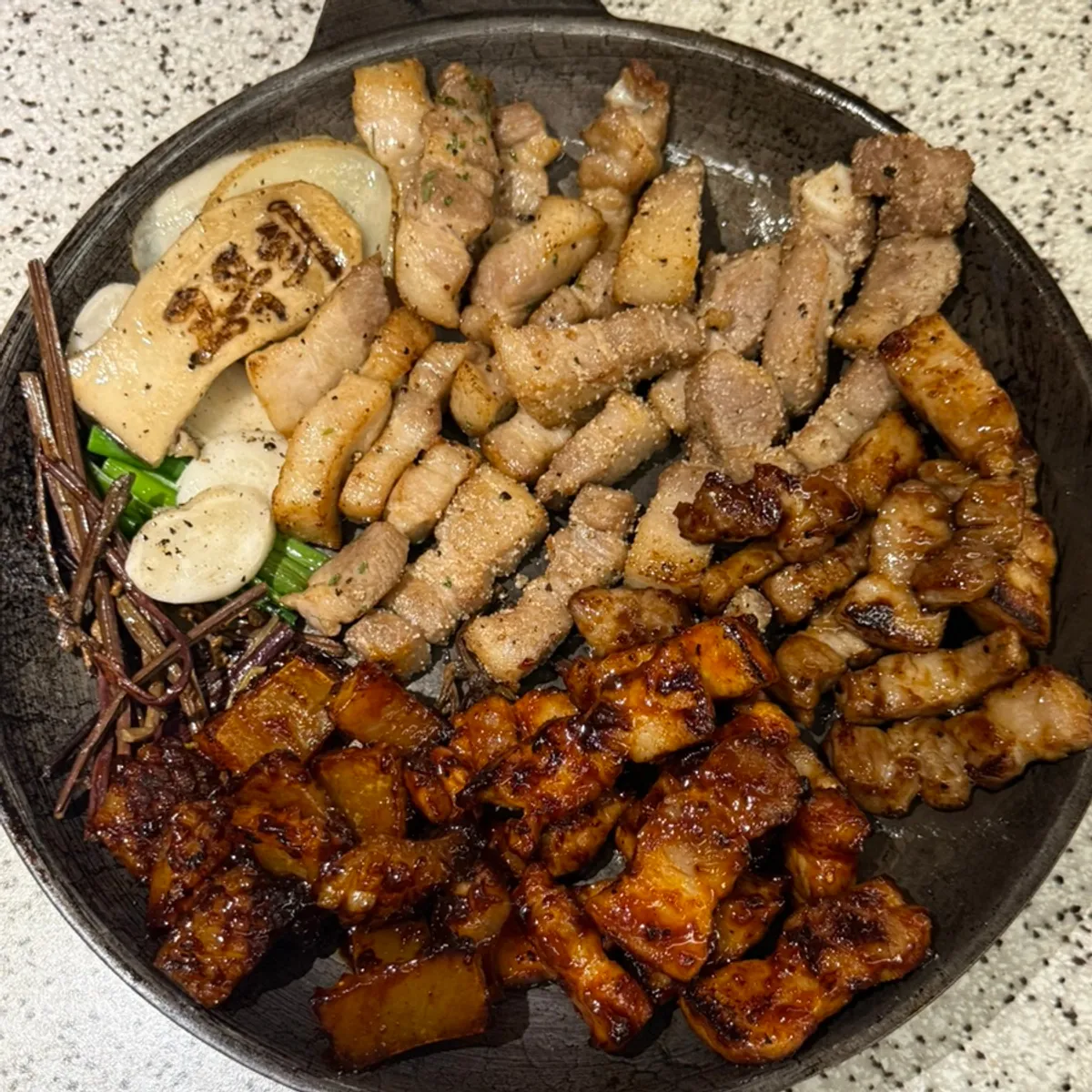 Close-up of grilled pork belly from the big platter