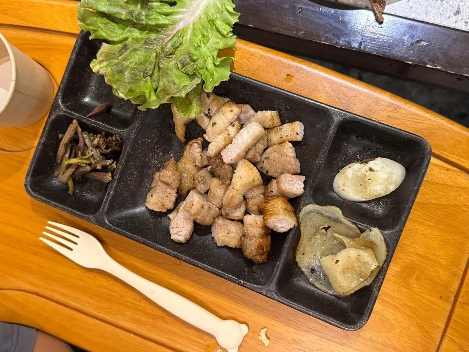 A piece of pork belly with side dishes