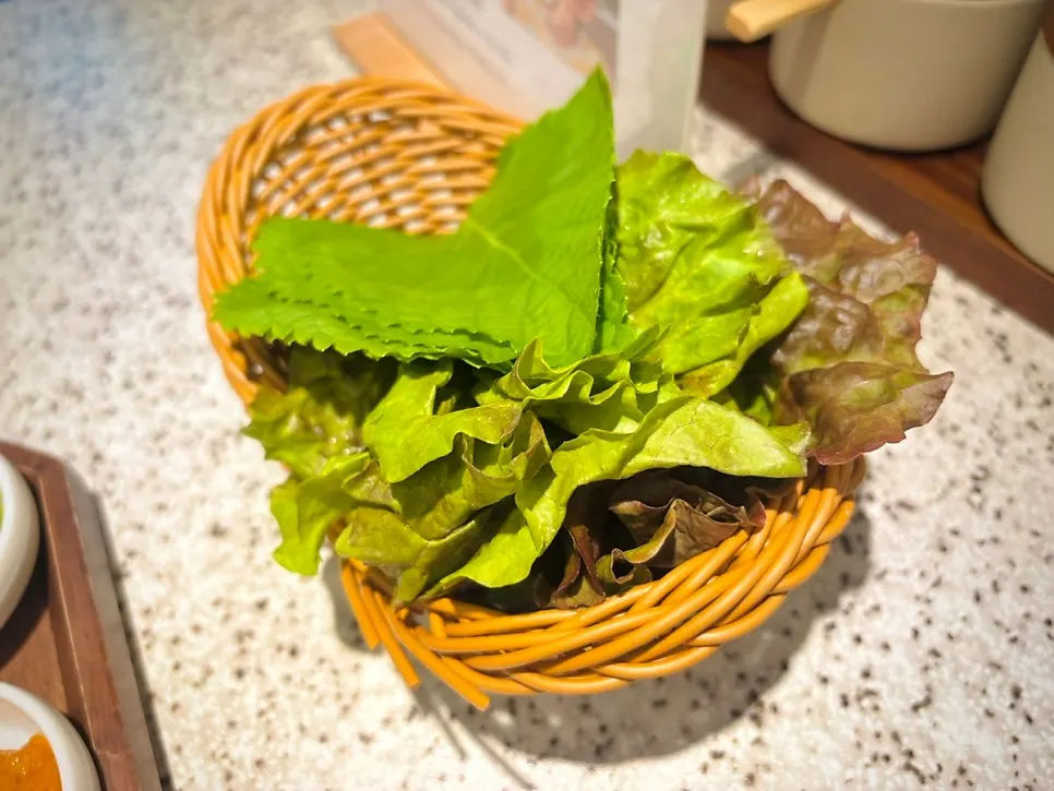 Side dishes and fresh lettuce wraps at Go Ok-hui