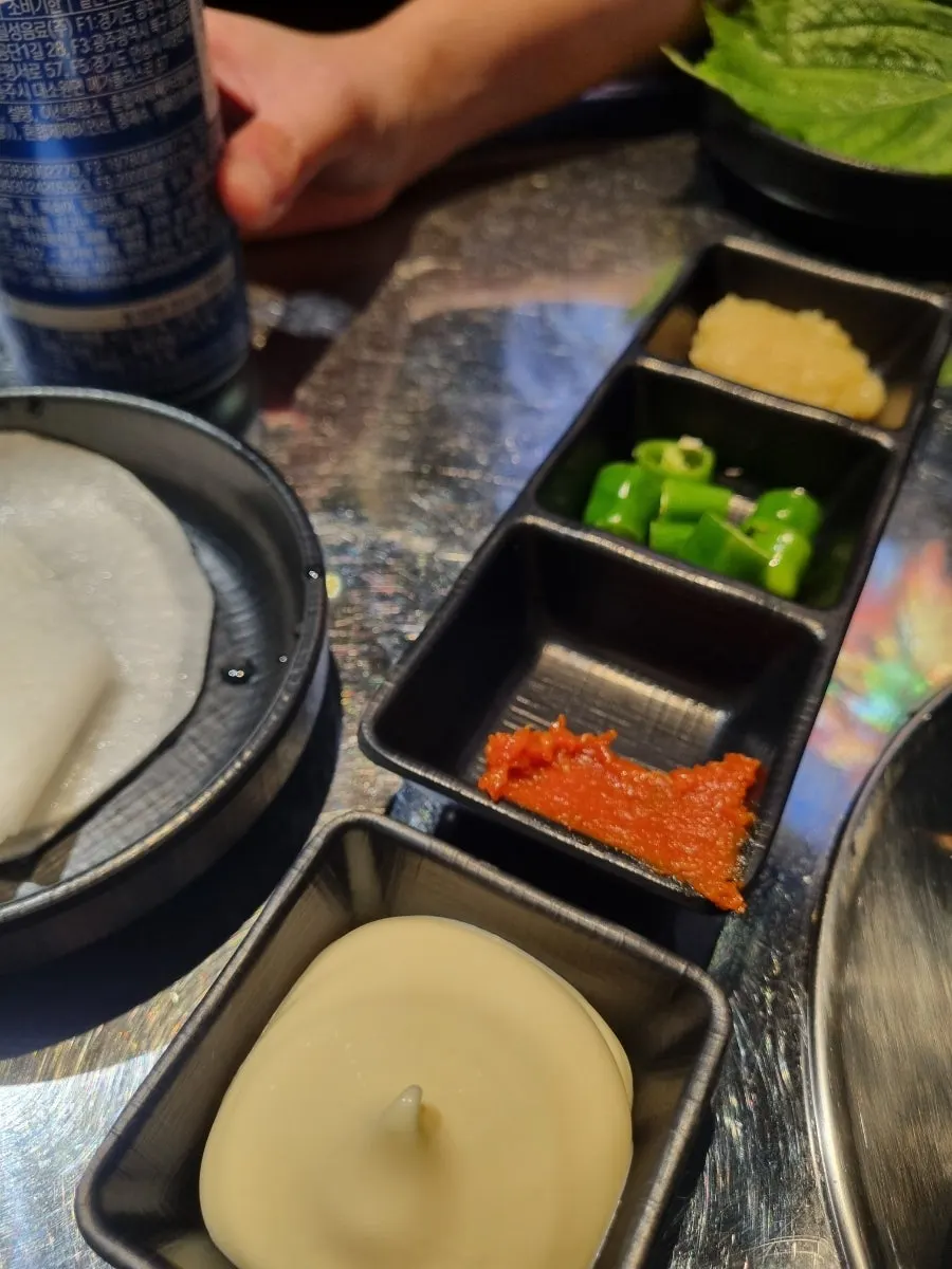 Basic table setting with mayonnaise, doenjang, gochujang, garlic, and pickled radish