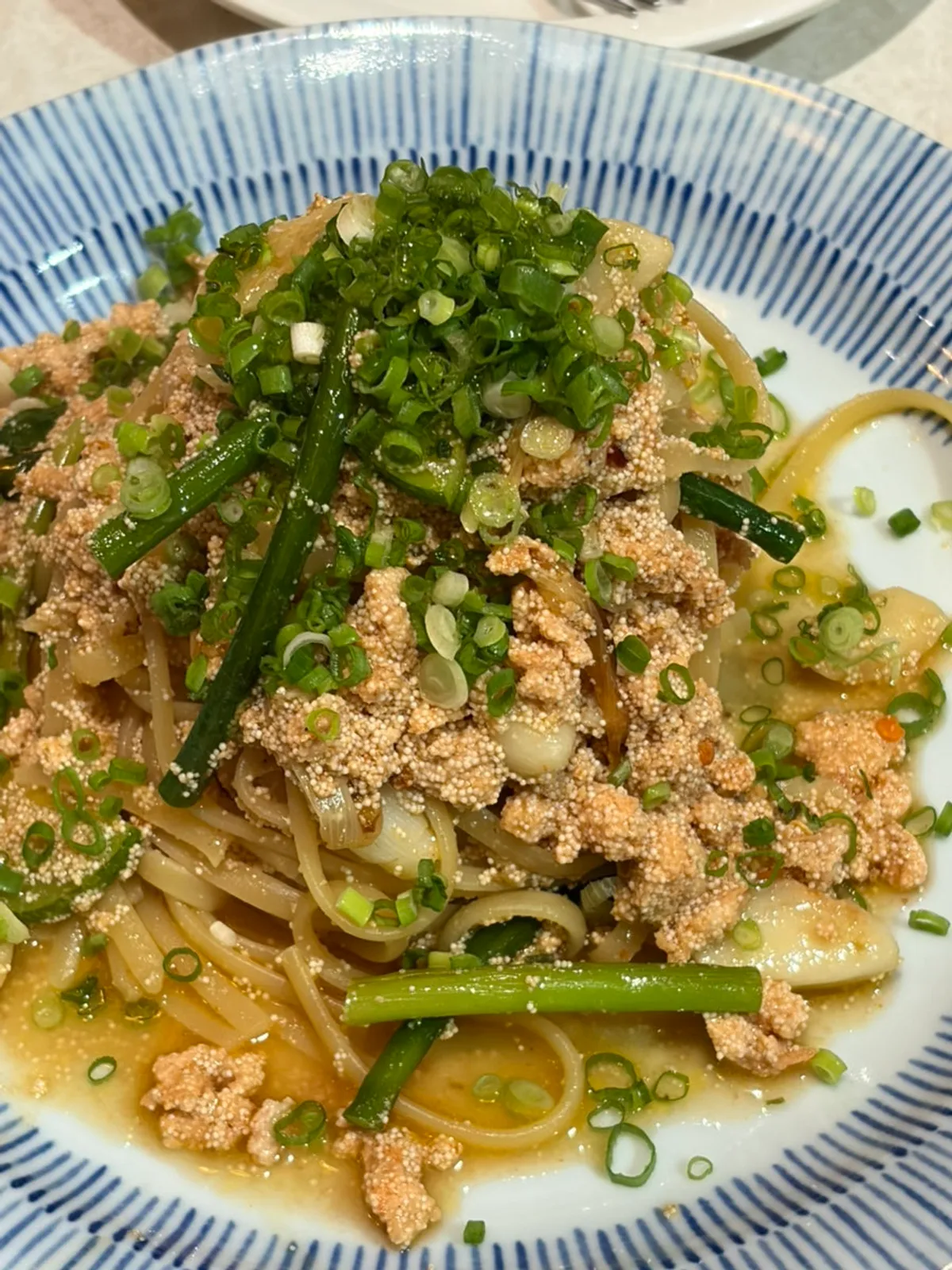 A bowl of daechang nabe portioned onto a plate