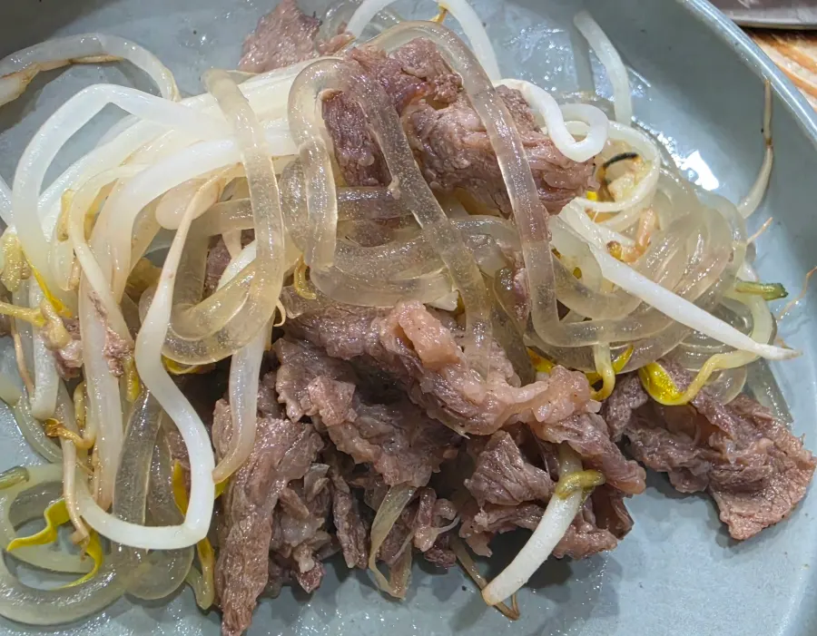 Flower beef bulgogi simmering in broth