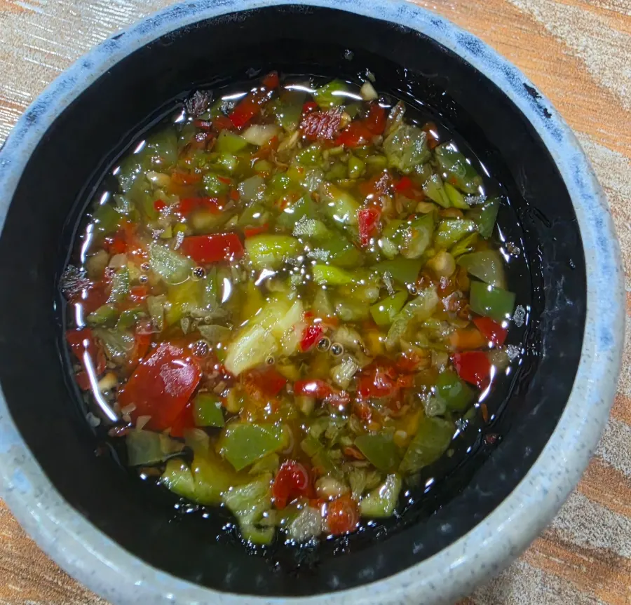 A piece of beef bulgogi picked up with chopsticks