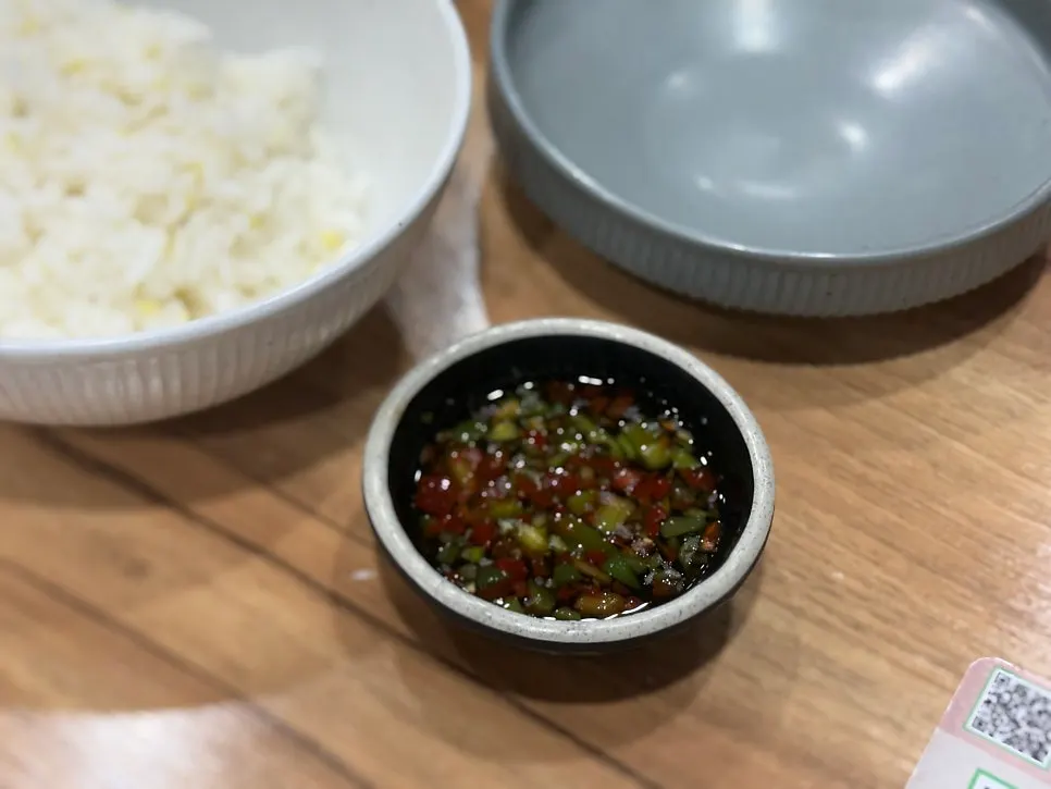 Water kimchi, seasoned radish, and dipping sauce side dishes