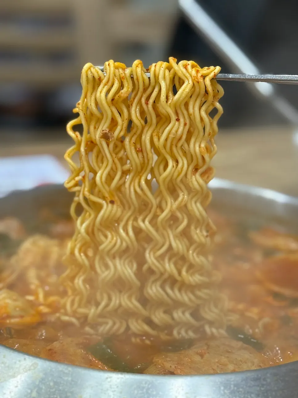 Ramen noodles added into the budae jjigae