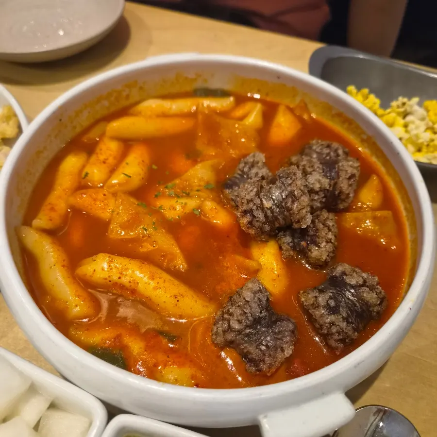 A piece of yukjeon topped with scallion salad