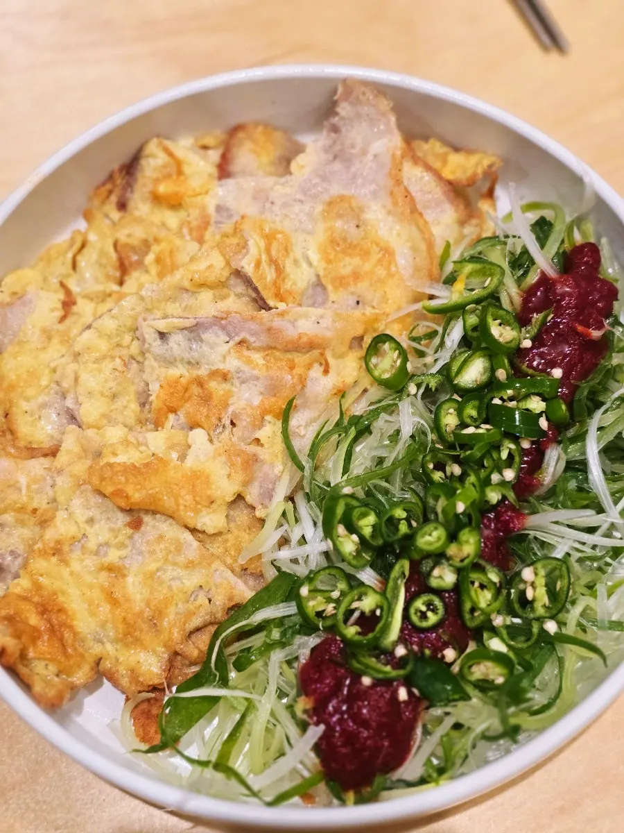 Pork jeon topped with scallion salad