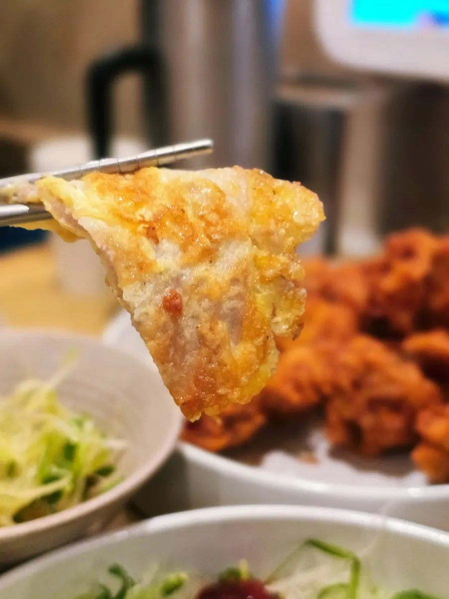 Table spread of chicken and jeon eaten together
