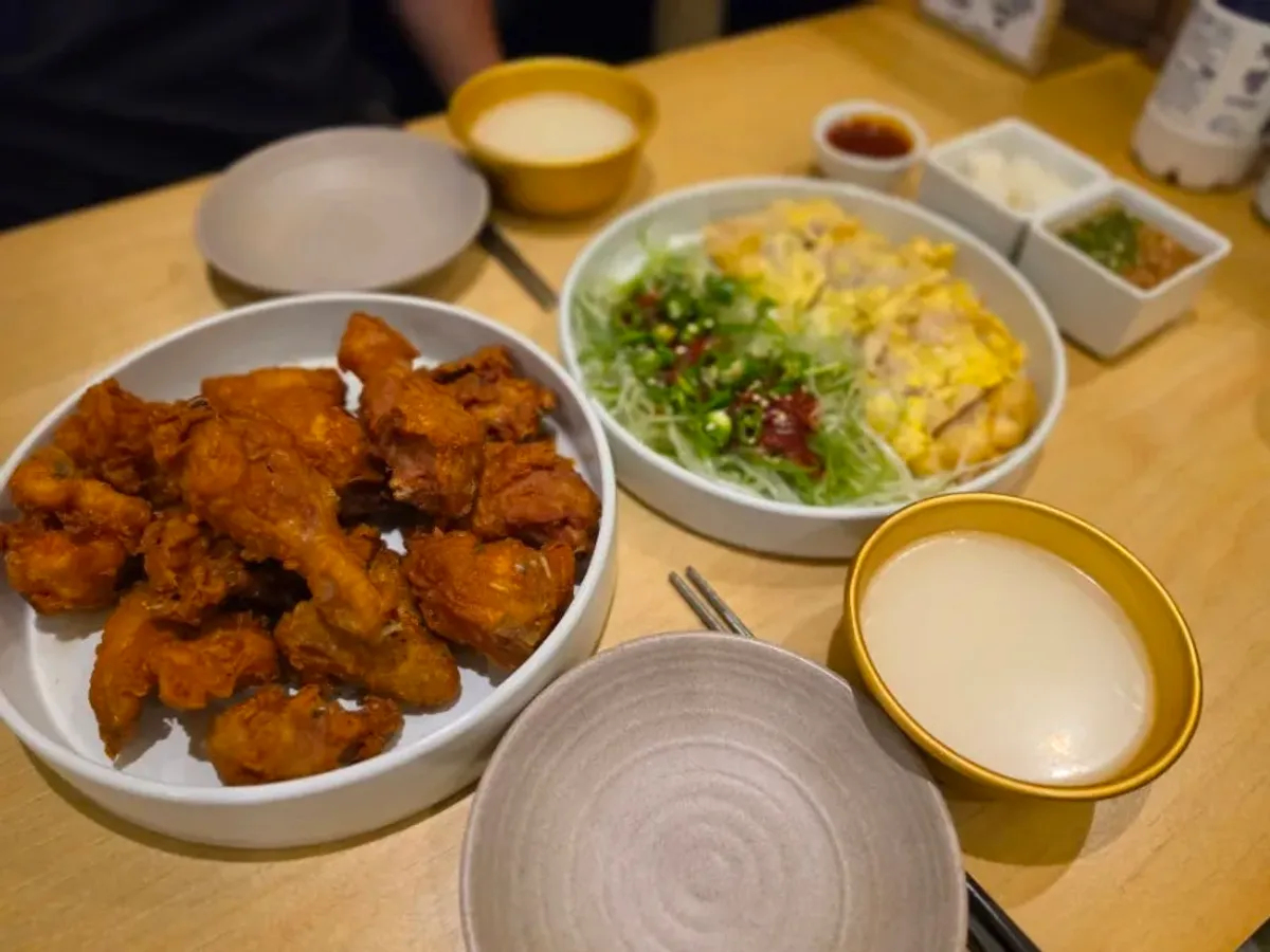 Full spread of chicken, pork jeon, and makgeolli on the table