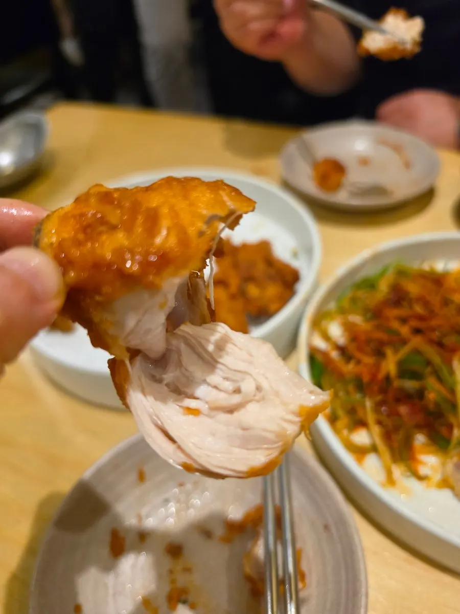 A crispy piece of Eungdapada Chicken