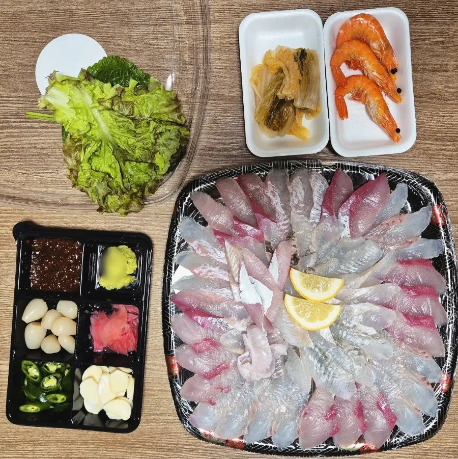 Sashimi packed with cooked shrimp, aged kimchi, and lettuce wraps