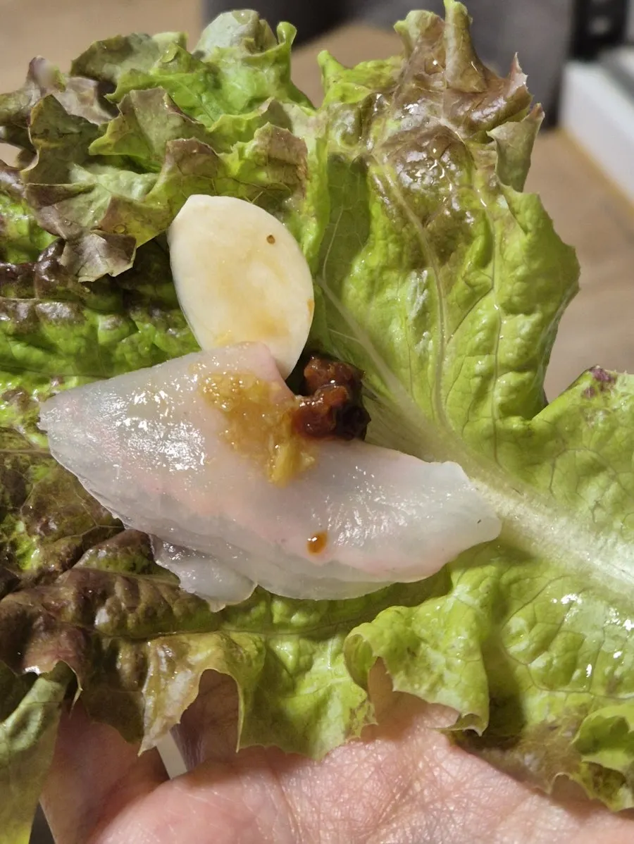 Lettuce wrap with sashimi, ssamjang, and garlic