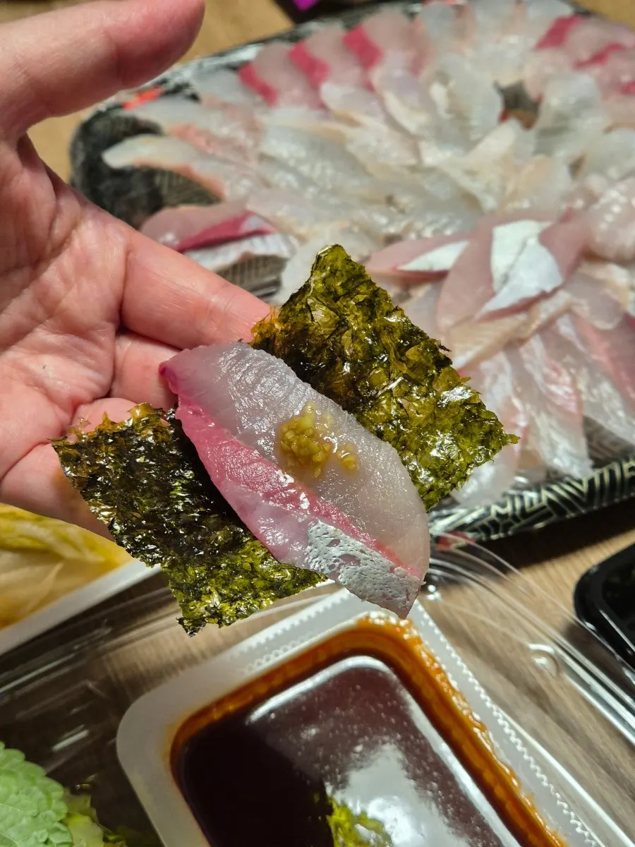 Nearly emptied plate of the medium mixed sashimi takeout