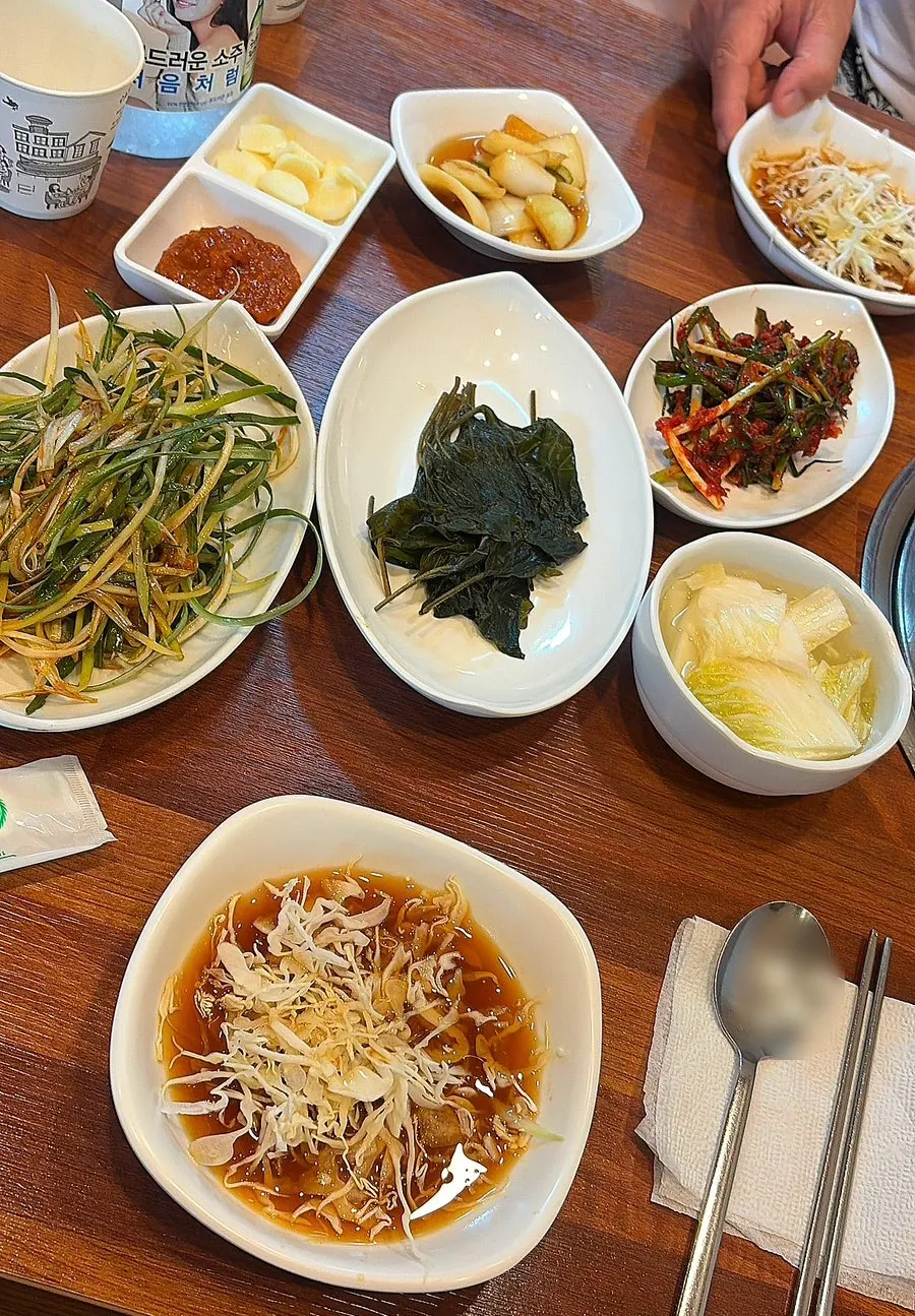 Side dishes including scallion salad and perilla leaf salad