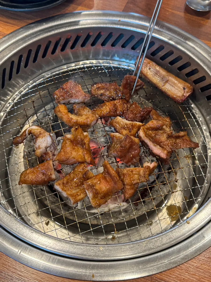 A full table set with pork ribs and side dishes
